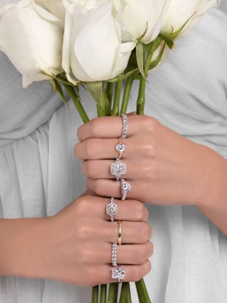 Diamond rings and a white bridal bouquet