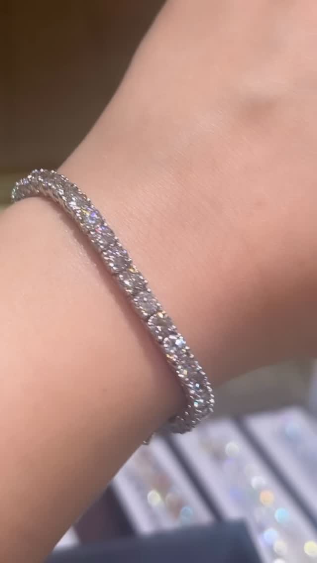 A diamond tennis bracelet worn on the wrist, from Diamond Concepts